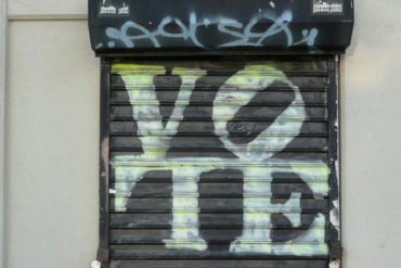 vote graffiti sprayed on shutters by vige