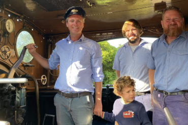 Joe Robertson and his son on the footplate of Calbourne with driver Steve and fireman Matt.