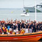 Cowes RNLI volunteers, friends and family wave to the camera alongside Atlantic 85 Lifeboat, Sheena Louise