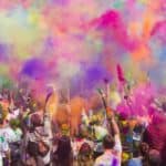 Crowd of people covered on coloured dust