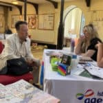 Resident sat with age uk advisors in St Catherine's Church