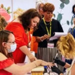 Maria Slade-Coombs being judged whilst painting nails