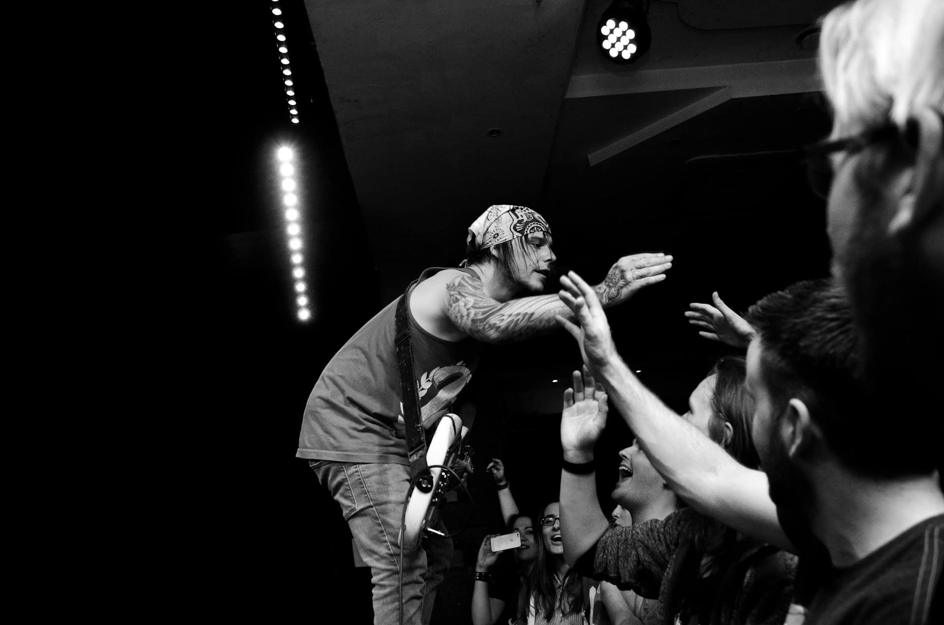 Musician on stage getting high fives from the audience