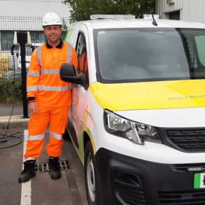 Aiden Reeves, District Steward standing by electric vehicles charging