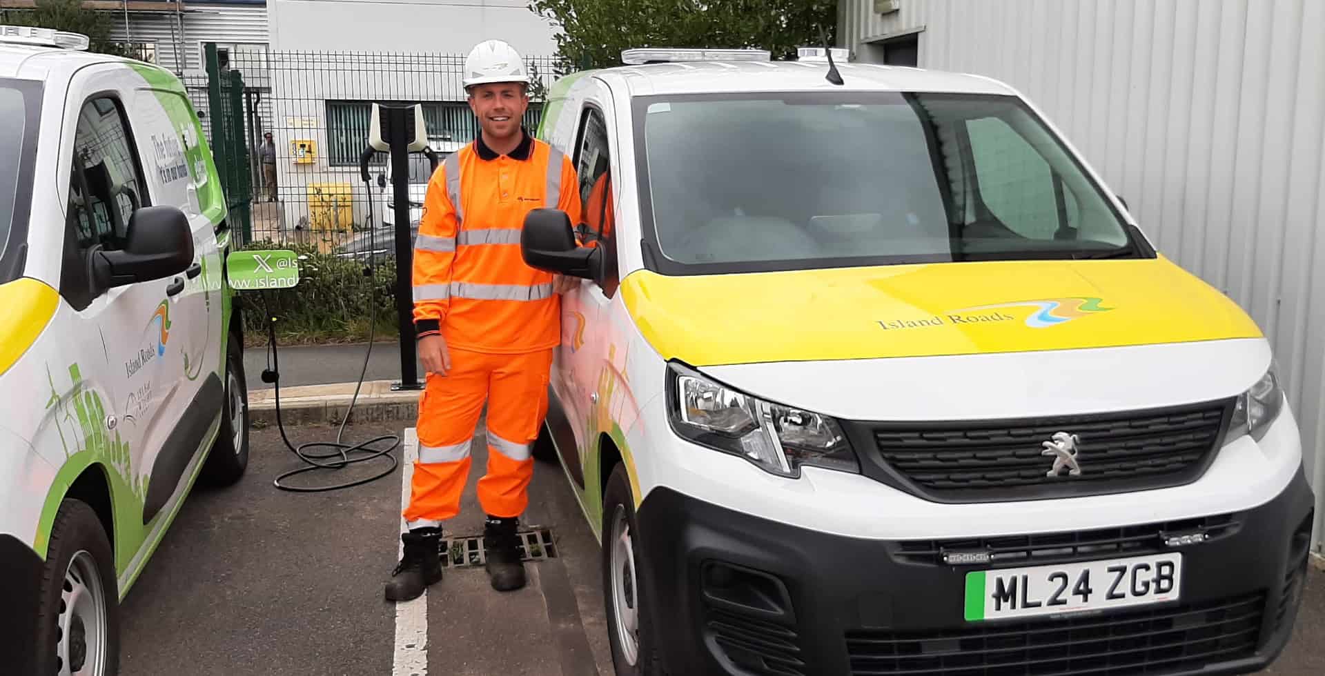 Aiden Reeves, District Steward standing by electric vehicles charging