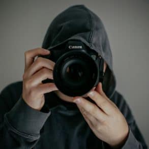 Person pointing a camera at the camera