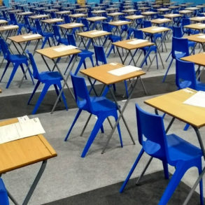 desks and chairs set up in a hall ready for exams