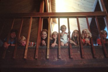 eight children looking through bannisters by national cancer institute