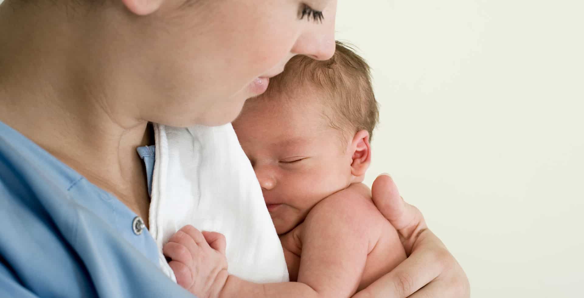 Mother holding her baby close to her chest