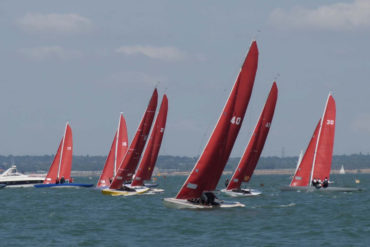 cowes week boats with red sails