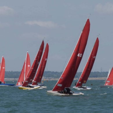 cowes week boats with red sails