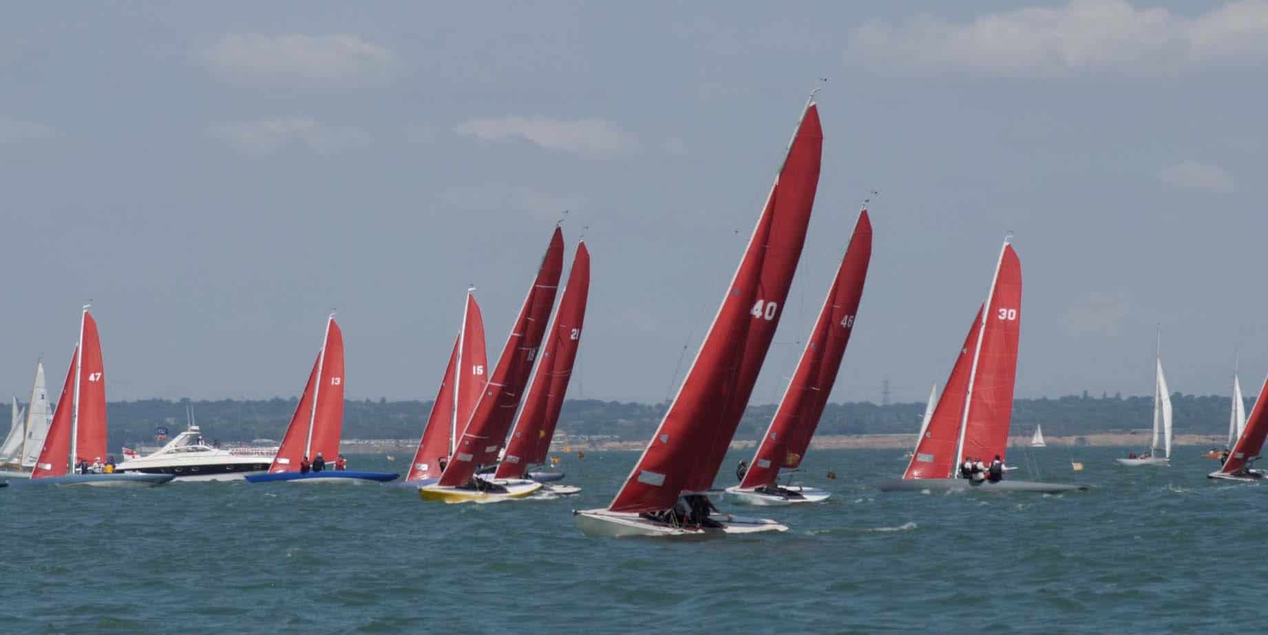 cowes week boats with red sails