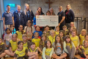 4th Sandown Brownies presenting a cheque to Mountbatten