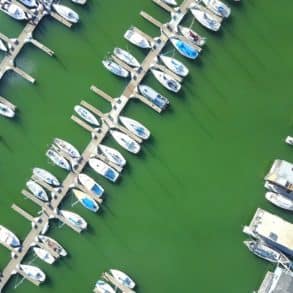 Aerial view of boats moored in a marina - andy wang