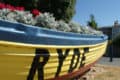 Boat filled with flowers and RYDE painted on the side