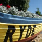 Boat filled with flowers and RYDE painted on the side