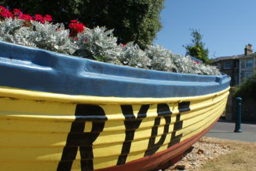 Boat filled with flowers and RYDE painted on the side