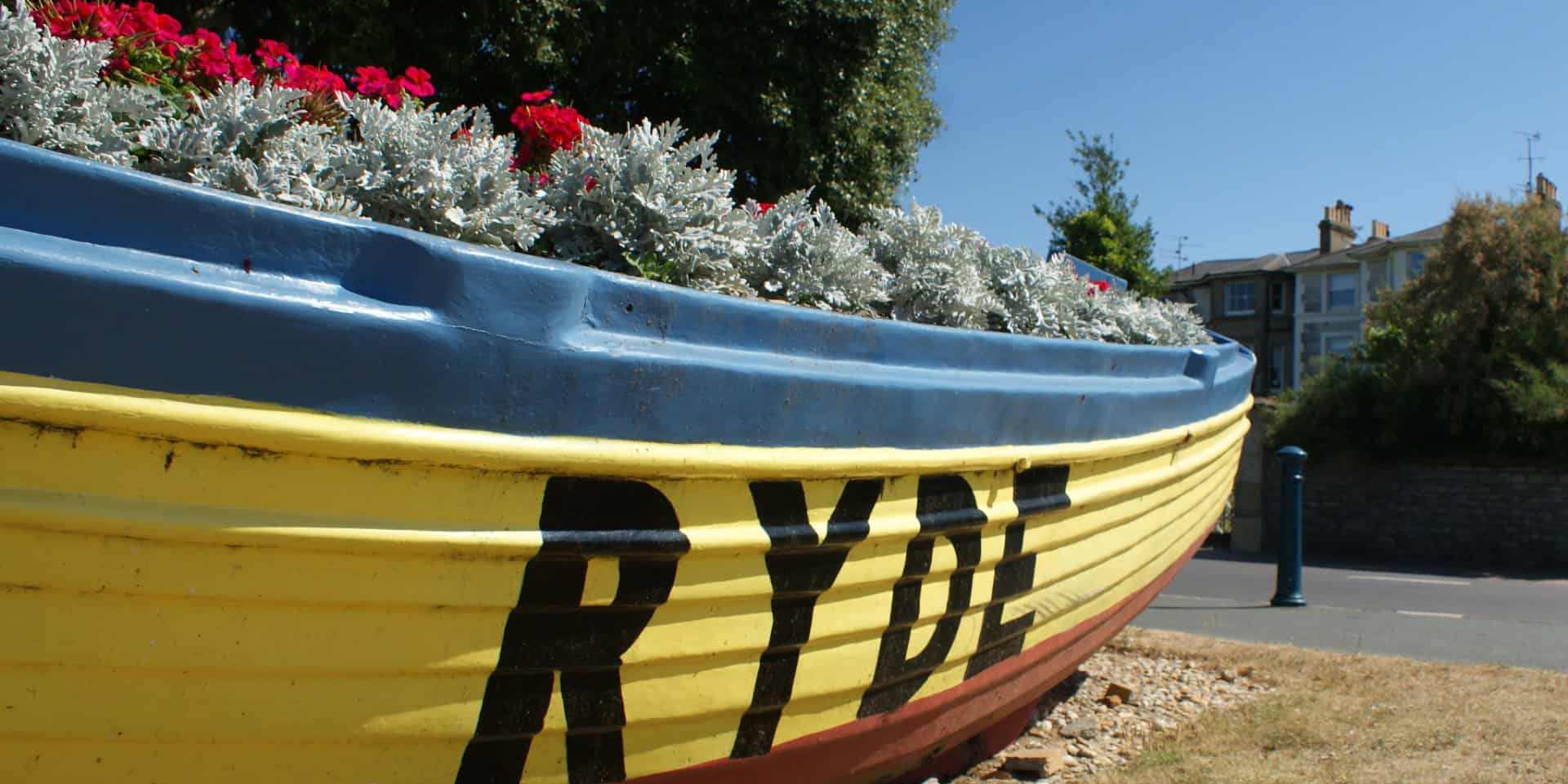 Boat filled with flowers and RYDE painted on the side