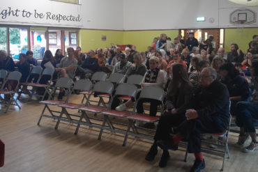 Cowes School Meeting - showing parents sitting in chairs waiting for the meeting to begin