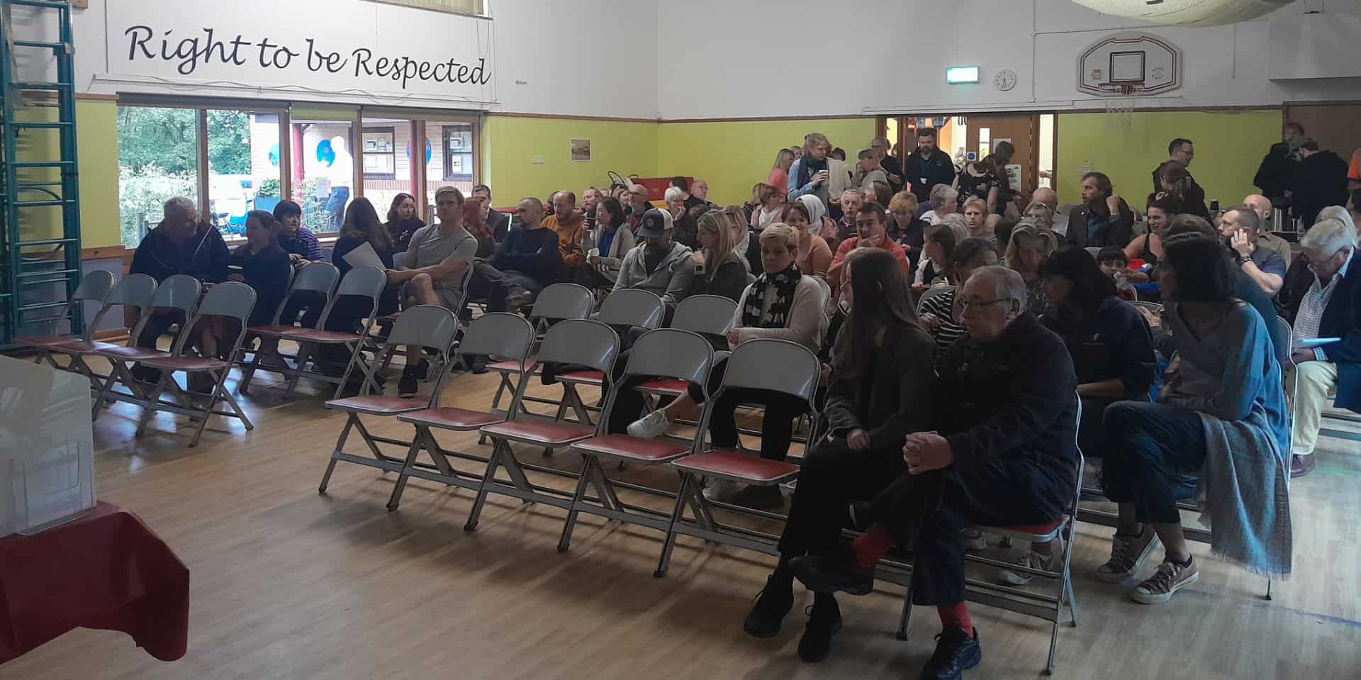 Cowes School Meeting - showing parents sitting in chairs waiting for the meeting to begin