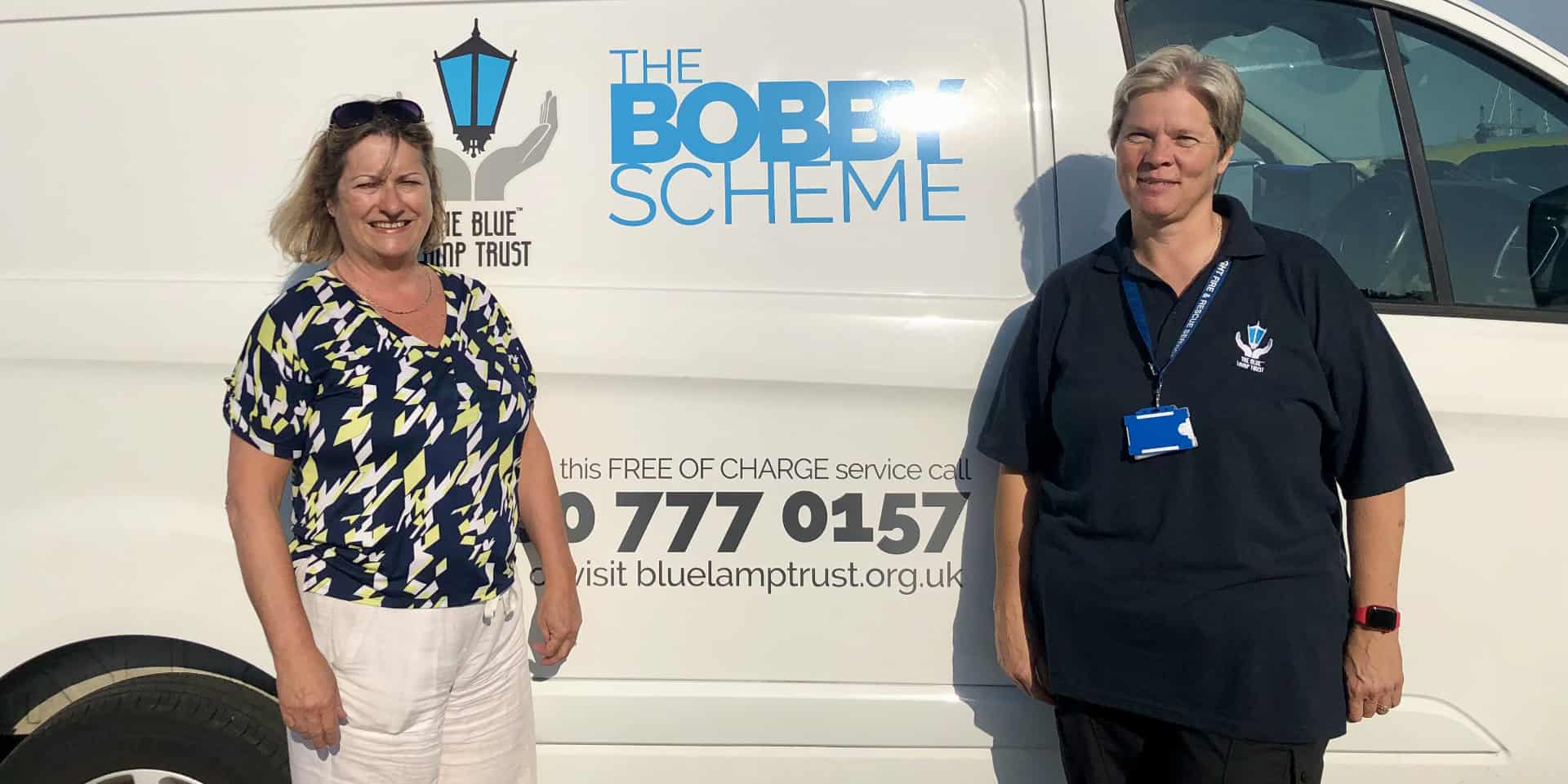 Lisa and Lois standing by Blue Lamp Trust van