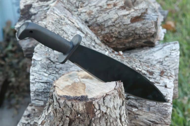 Machete knife in a log