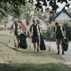 People litter picking in a park