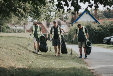 People litter picking in a park