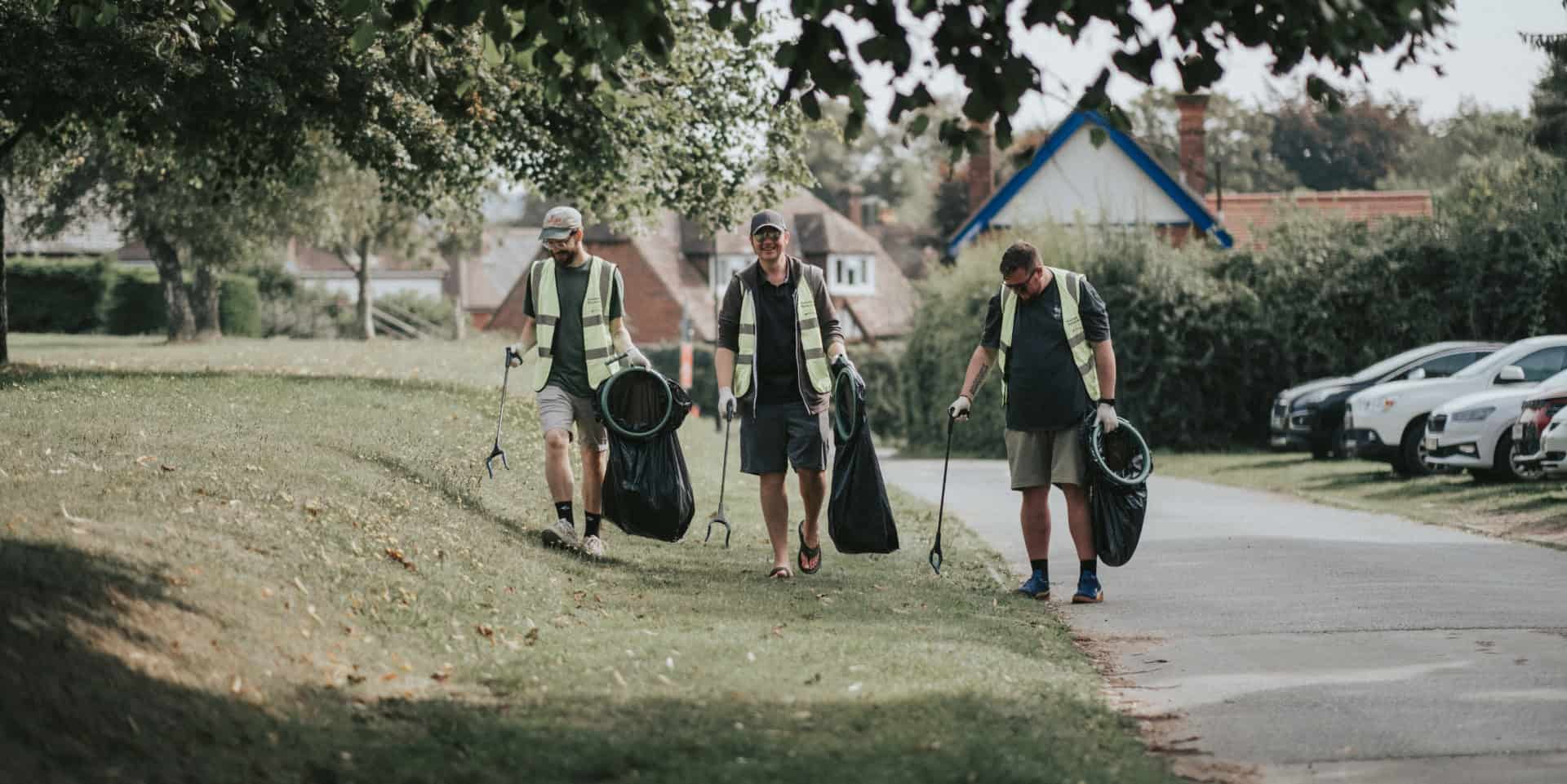 People litter picking in a park