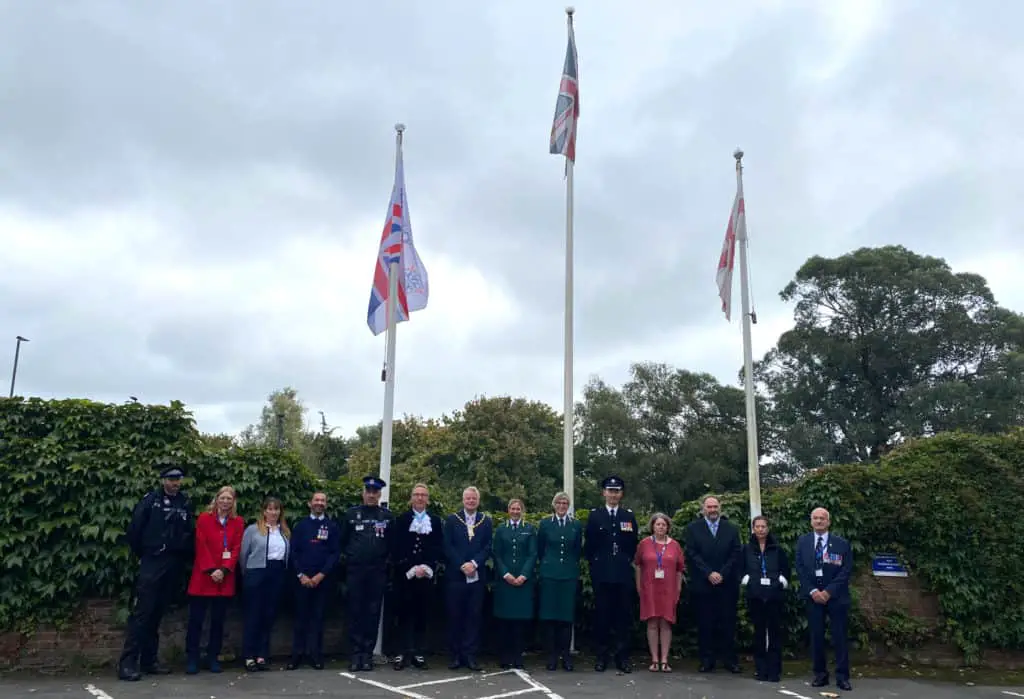 Sergeant Matt Browne, Councillor Debbie Andre, Wendy Perera IWC Chief Executive, Mark Southwell Cowes RNLI, a representative from Police, Graham Biss High Sheriff, Councillor Karl Love IWC Chairman, Flag Raiser Louise Walker and Victoria White from Ambulance service,  Jeff Walls Hampshire and IOW Fire service, Jayne Tyler, Councillor Chris Jarman, Councillor Claire Mosdell, Councillor Ian Ward