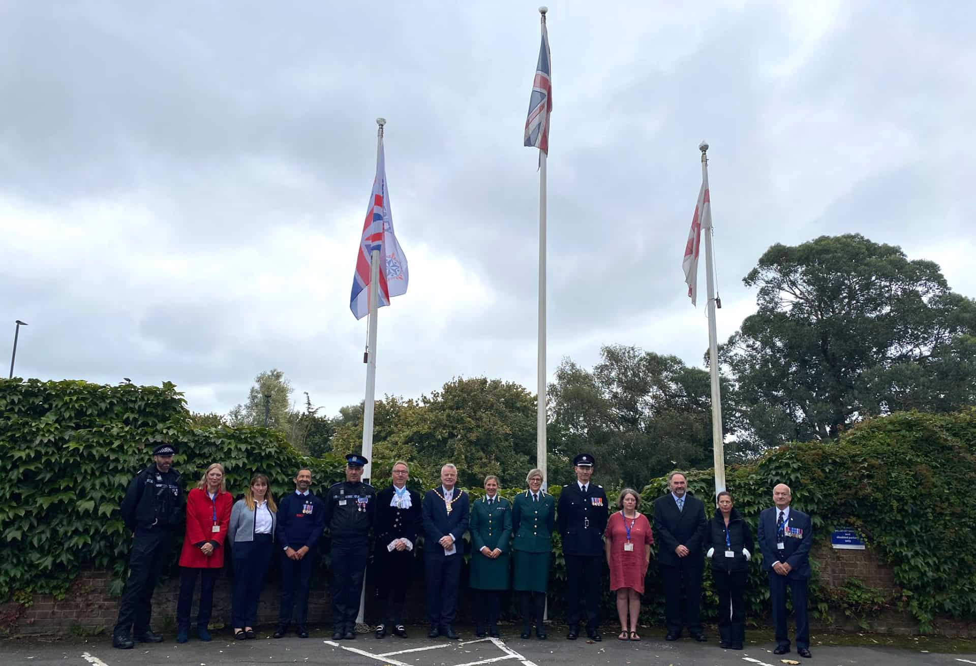 Sergeant Matt Browne, Councillor Debbie Andre, Wendy Perera IWC Chief Executive, Mark Southwell Cowes RNLI, a representative from Police, Graham Biss High Sheriff, Councillor Karl Love IWC Chairman, Flag Raiser Louise Walker and Victoria White from Ambulance service, Jeff Walls Hampshire and IOW Fire service, Jayne Tyler, Councillor Chris Jarman, Councillor Claire Mosdell, Councillor Ian Ward