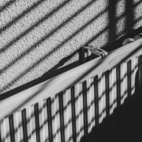 black and white image of a radiator with shadow of venetian blinds