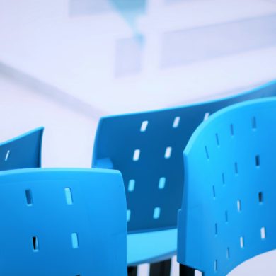 blue plastic chairs in a waiting room