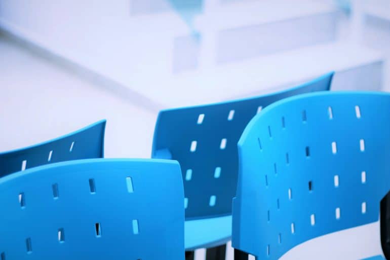 blue plastic chairs in a waiting room