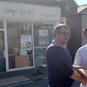 ieuan jehu handing over petition to richard quigley MP outside mydentist Freshwater