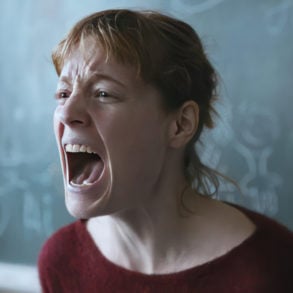 scene from The Teachers' Lounge showing a teacher standing by the blackboard screaming