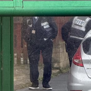 traffic wardens ticketing cars parked in restricted areas