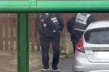 traffic wardens ticketing cars parked in restricted areas