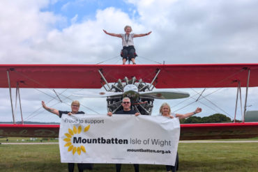 Mountbatten’s director of operations, Becky McGregor, sitting on top of the Ethel Dares Wing Walking plane, with (front, from left) Mountbatten nurse Rhoda Thomas, Kevin Foss, Mountbatten nurse Jackie Whiller