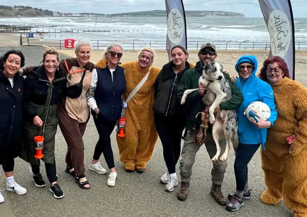 Women taking part in the Barefoot walk dressed in bear outfits