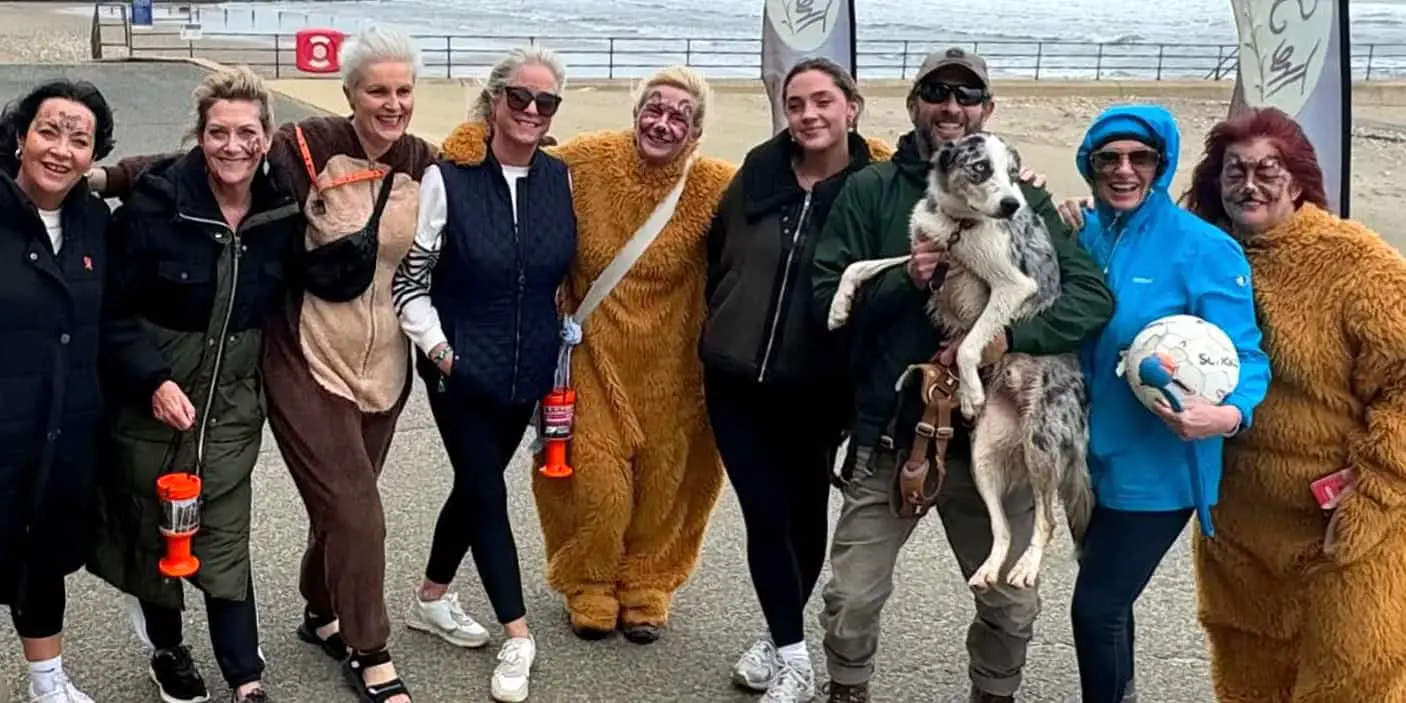 Women taking part in the Barefoot walk dressed in bear outfits