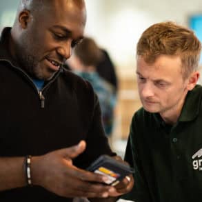 Energywise meeting men looking at app on the mobile phone