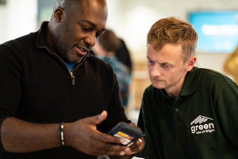 Energywise meeting men looking at app on the mobile phone