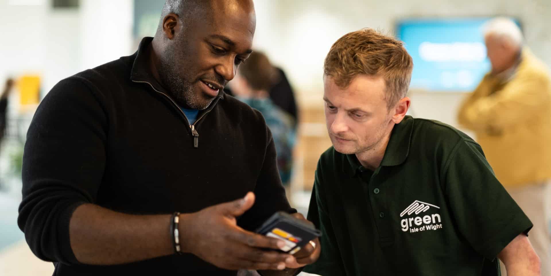 Energywise meeting men looking at app on the mobile phone