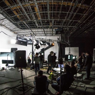 Inside a film studio, with lots of cameras and lighting