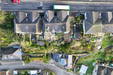 Aerial view of properties with damaged gardens