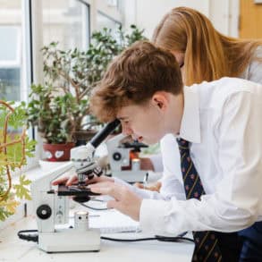 Ryde School With Upper Chine pupils looking through a microscope