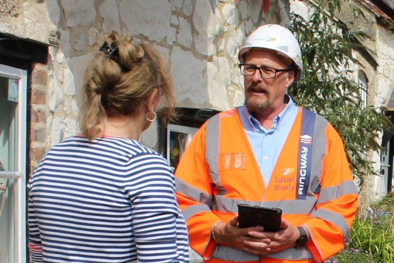 Island roads worker talking to resident