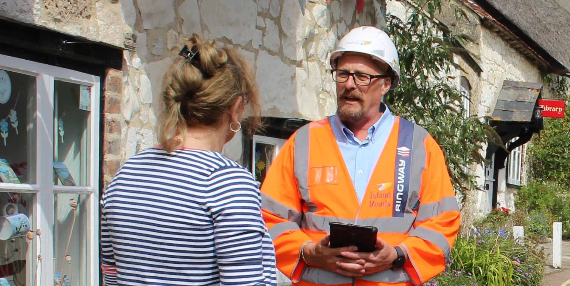 Island roads worker talking to resident