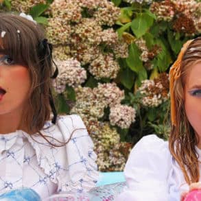 Band members sitting in an inflatable pool filled with bubble bath